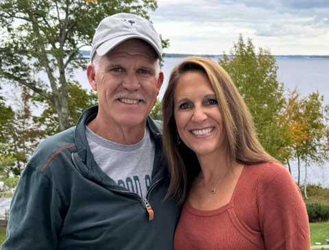 daniel and kim gogan with southern maine coastline in the background